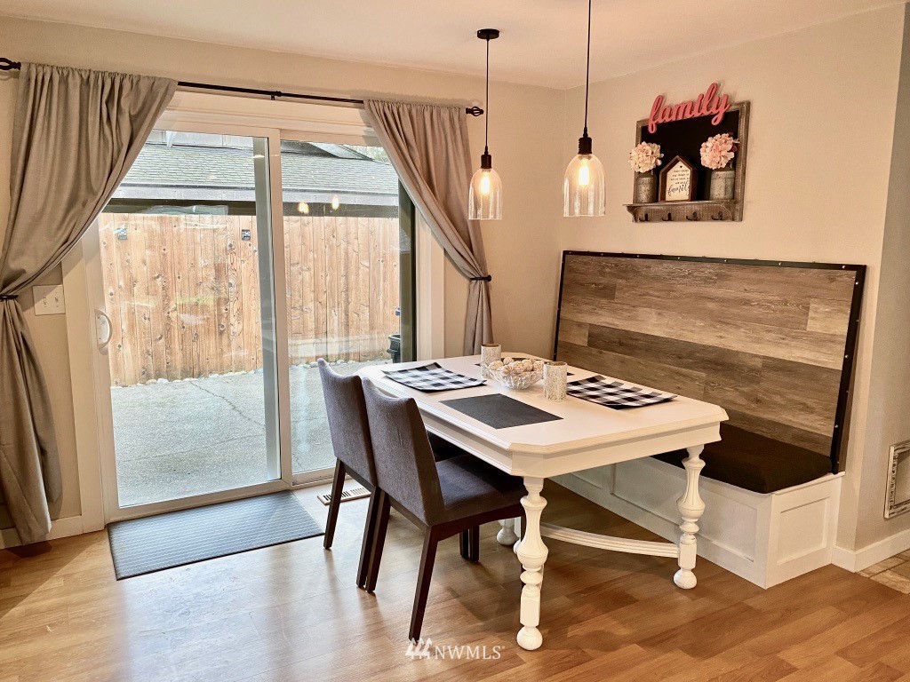 14530 166th Place Southeast Renton, WA 98059 - Photo 10 of 30 a view of a dining room with furniture window and wooden floor