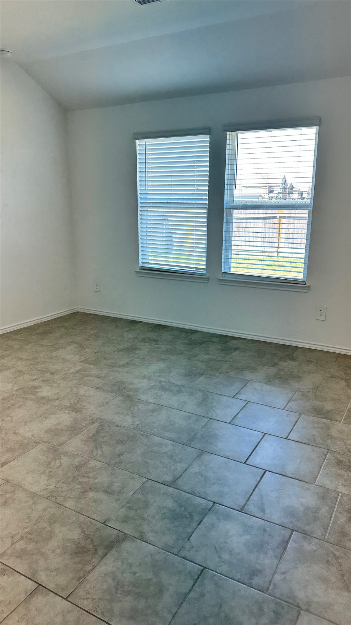 1103 Cattle Chute Court Rosharon, TX 77583 - Photo 21 of 26 Bright room with tile flooring, featuring two large windows with blinds, offering plenty of natural light.