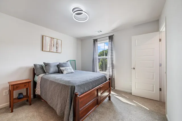 a bed room with a bed and a window