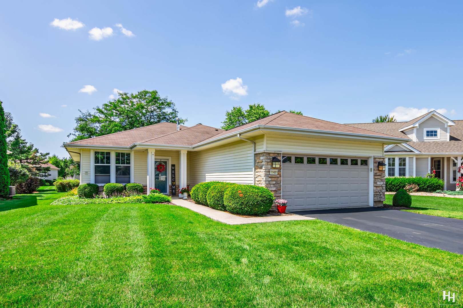11481 Primrose Court Huntley, IL 60142 - Photo 1 of 32 a front view of a house with a garden and plants