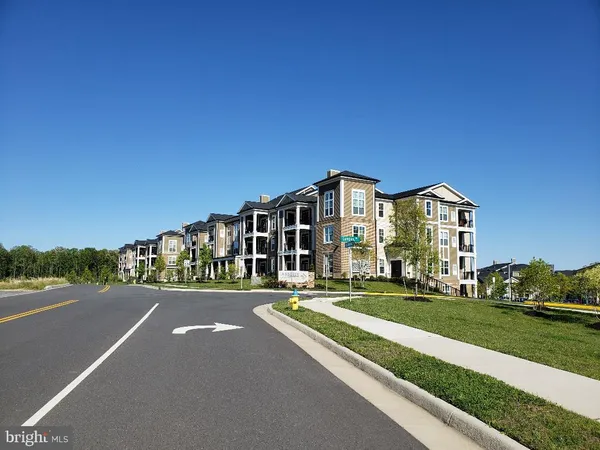 a city street lined with parked cars and buildings