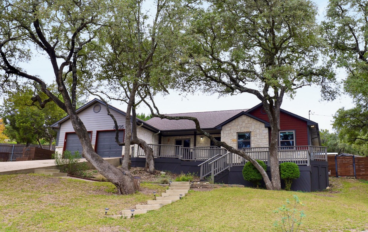 a view of a house with backyard porch and sitting area