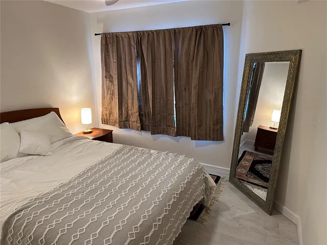 a bedroom with a bed and a mirror