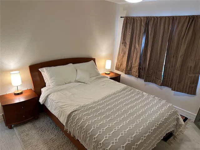 a bedroom with a bed and a mirror