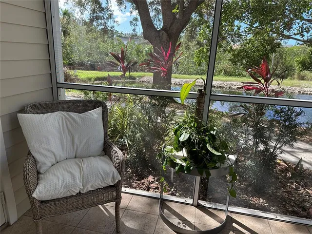 a view of a porch with furniture and garden