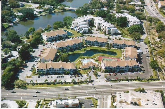 an aerial view of residential houses with outdoor space and lake view