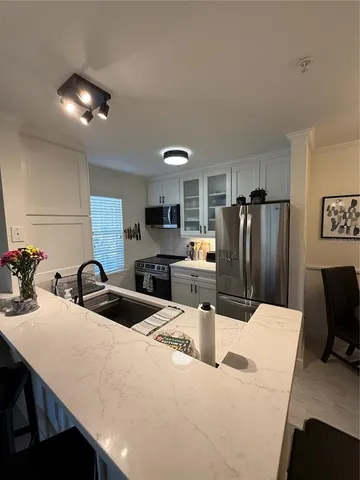 a kitchen with a refrigerator and a sink