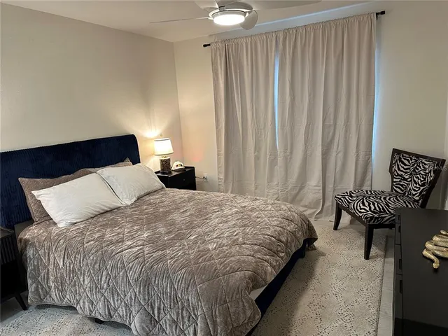 a bedroom with a bed and a chair