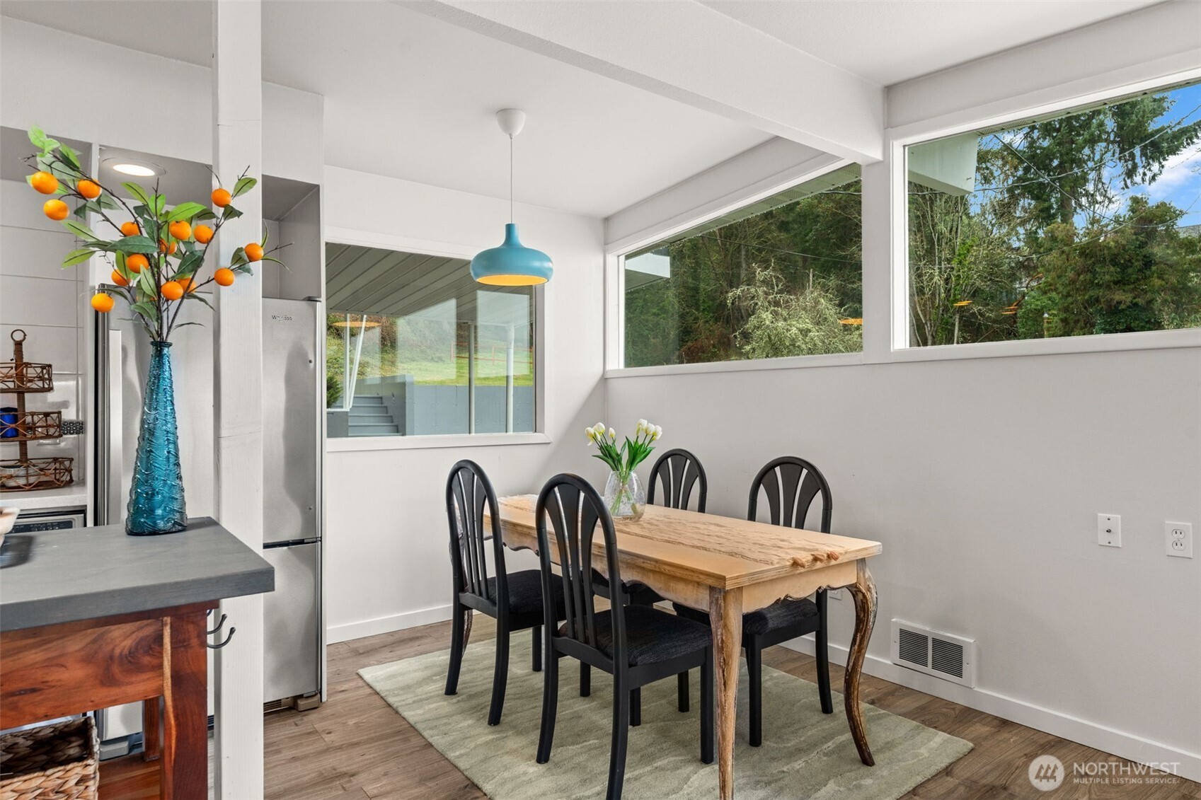 1908 Lybecker Road Northwest Gig Harbor, WA 98332 - Photo 18 of 40 a view of a dining room with furniture a chandelier and wooden floor