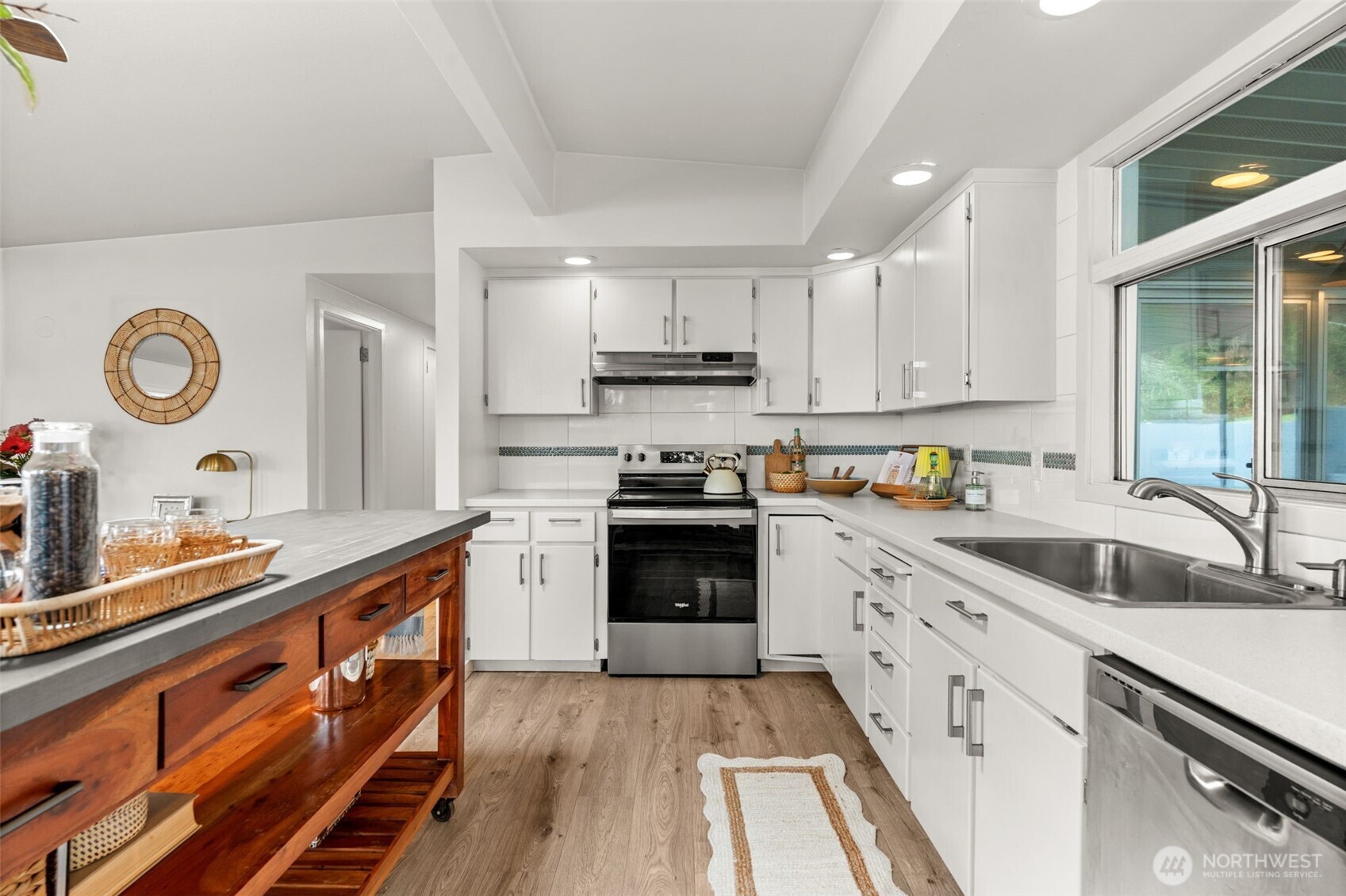 1908 Lybecker Road Northwest Gig Harbor, WA 98332 - Photo 20 of 40 a kitchen with granite countertop a sink stove and cabinets