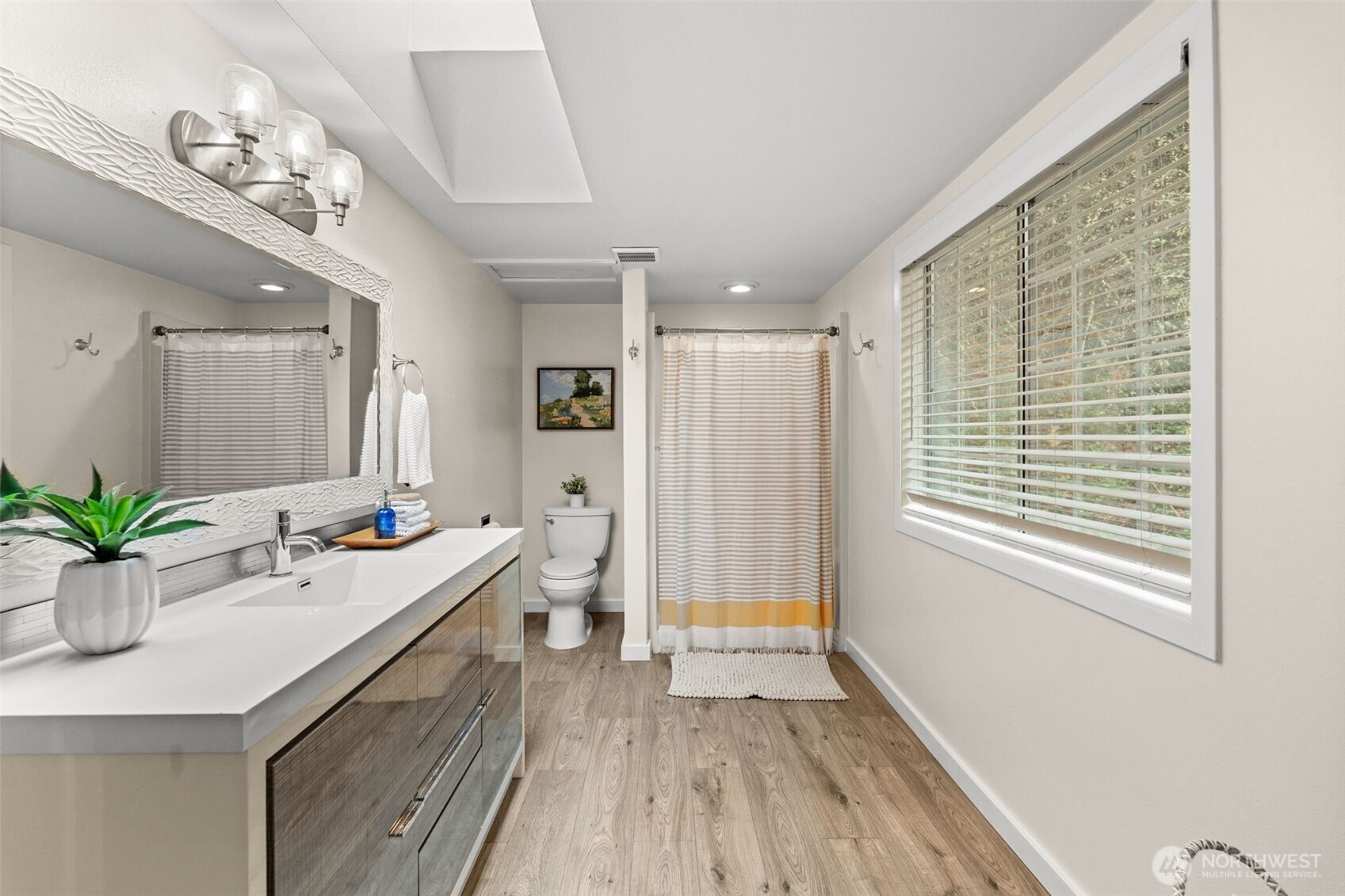 1908 Lybecker Road Northwest Gig Harbor, WA 98332 - Photo 27 of 40 a bathroom with a double vanity sink a large mirror and a shower