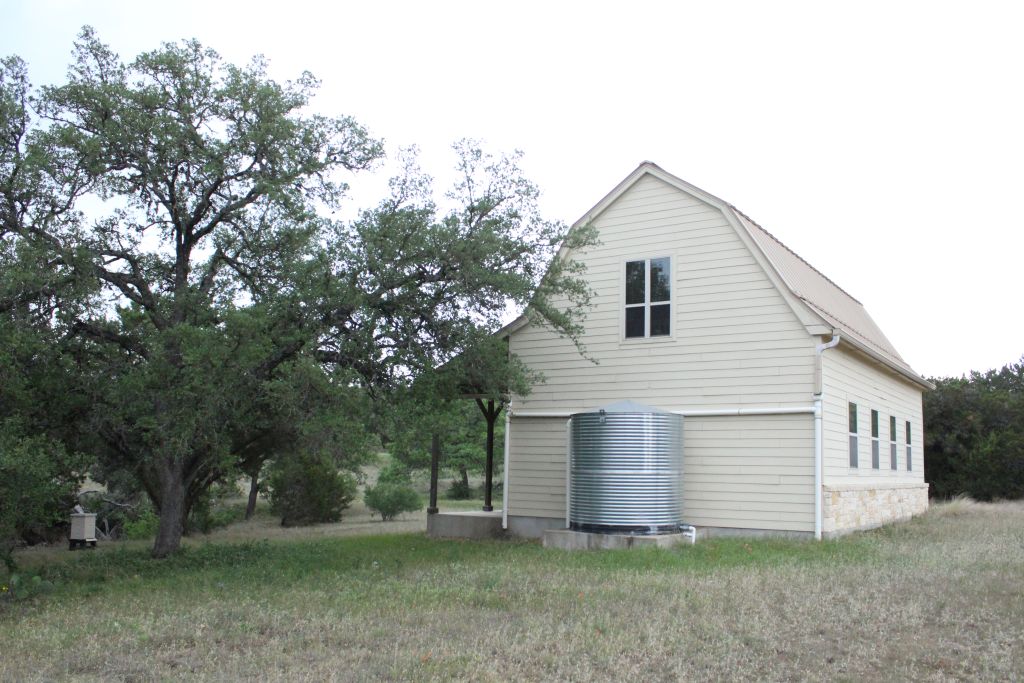 5135 Lookout Ridge Drive Marble Falls, TX 78654 - Photo 25 of 33 Barn backyard with water collection cistern