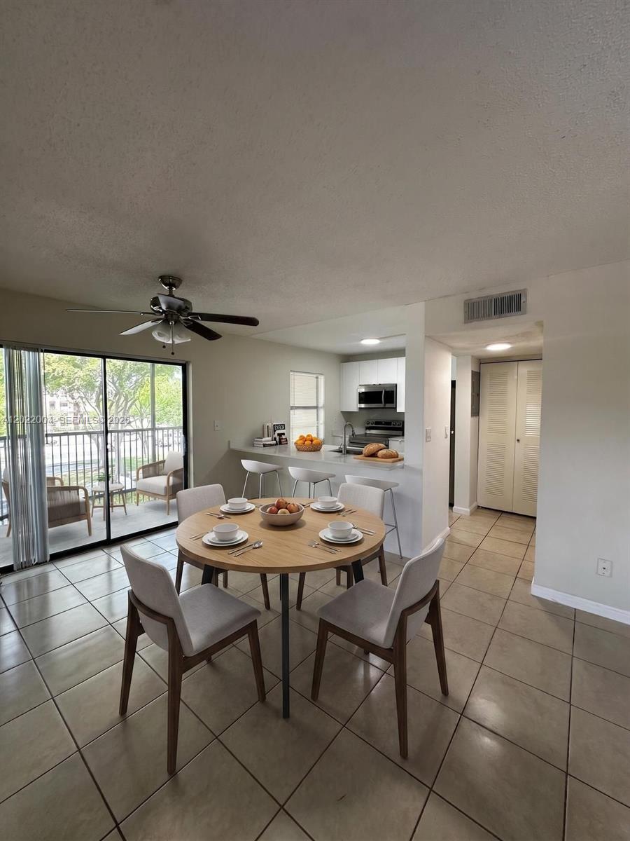 3400 Foxcroft Road, Unit 301 Miramar, FL 33025 - Photo 3 of 72 a view of a dining room with furniture and window