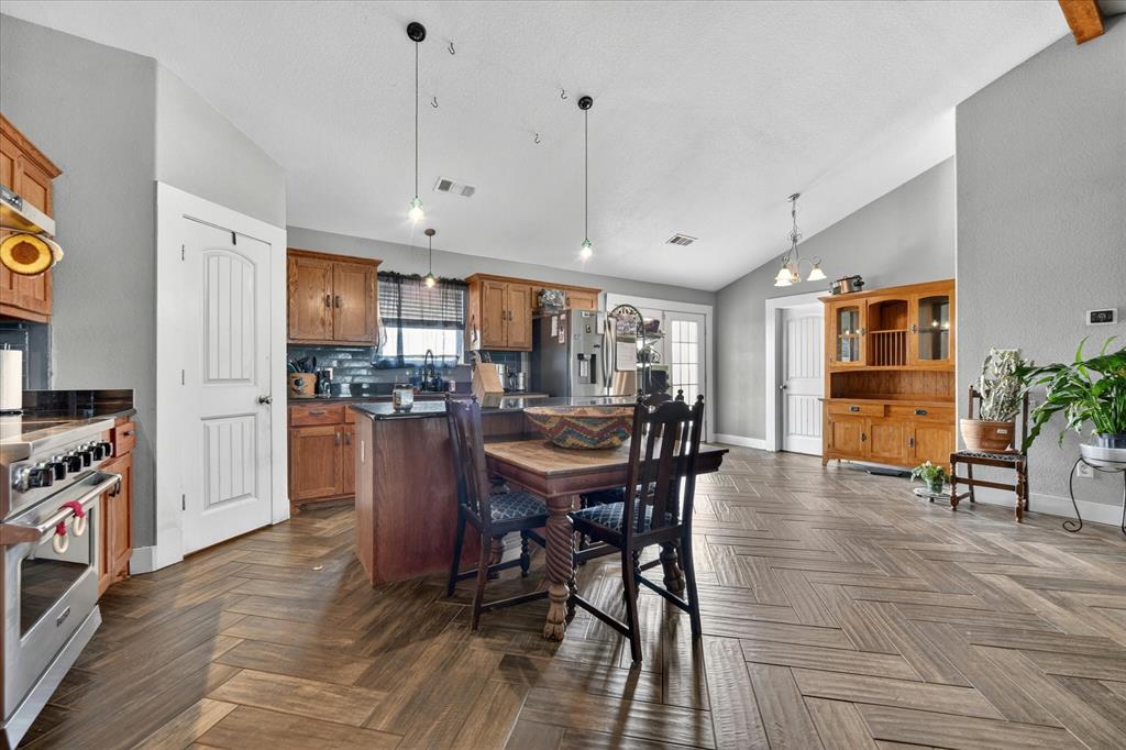 7145 Donald Road Krum, TX 76249 - Photo 13 of 35 a view of a dining room with furniture and wooden floor