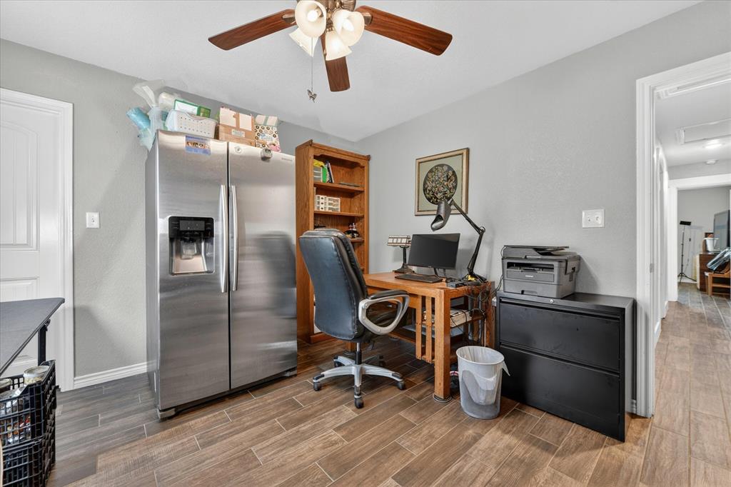 7145 Donald Road Krum, TX 76249 - Photo 16 of 35 a view of a workspace with furniture and wooden floor