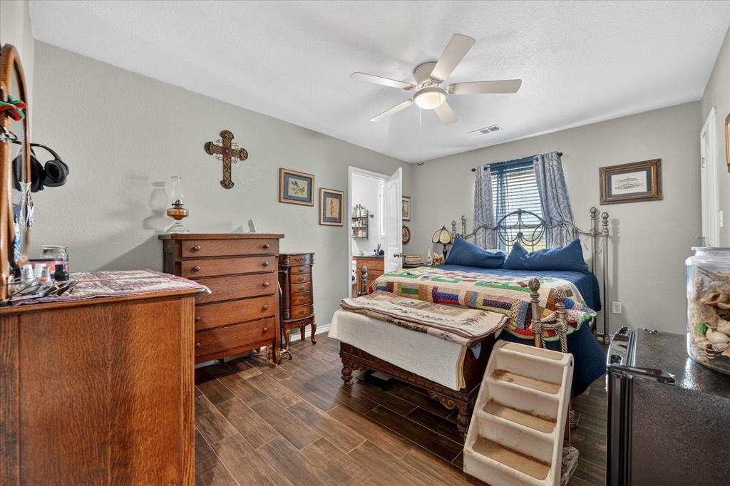 7145 Donald Road Krum, TX 76249 - Photo 18 of 35 a bedroom with furniture and a chandelier