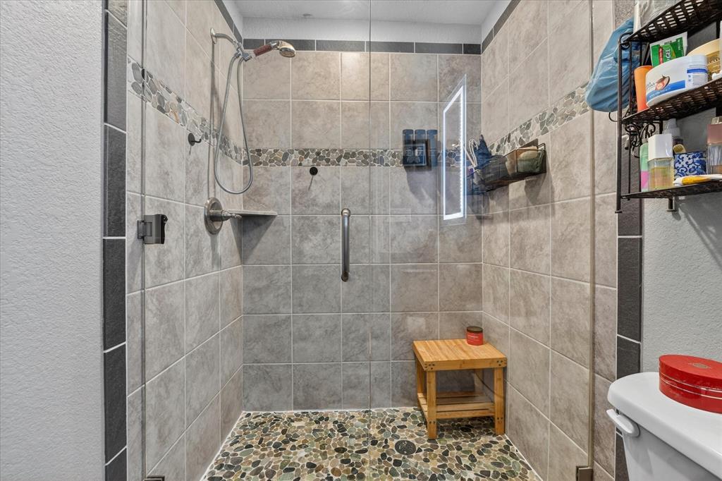 7145 Donald Road Krum, TX 76249 - Photo 21 of 35 a bathroom with a shower
