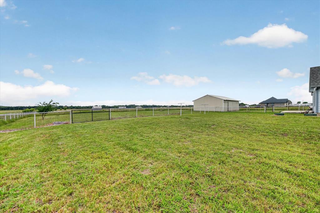 7145 Donald Road Krum, TX 76249 - Photo 30 of 35 a view of a golf course with a lake