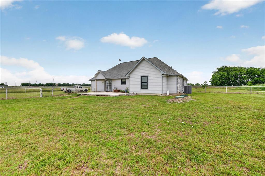 7145 Donald Road Krum, TX 76249 - Photo 31 of 35 a view of a house with a yard and a large tree
