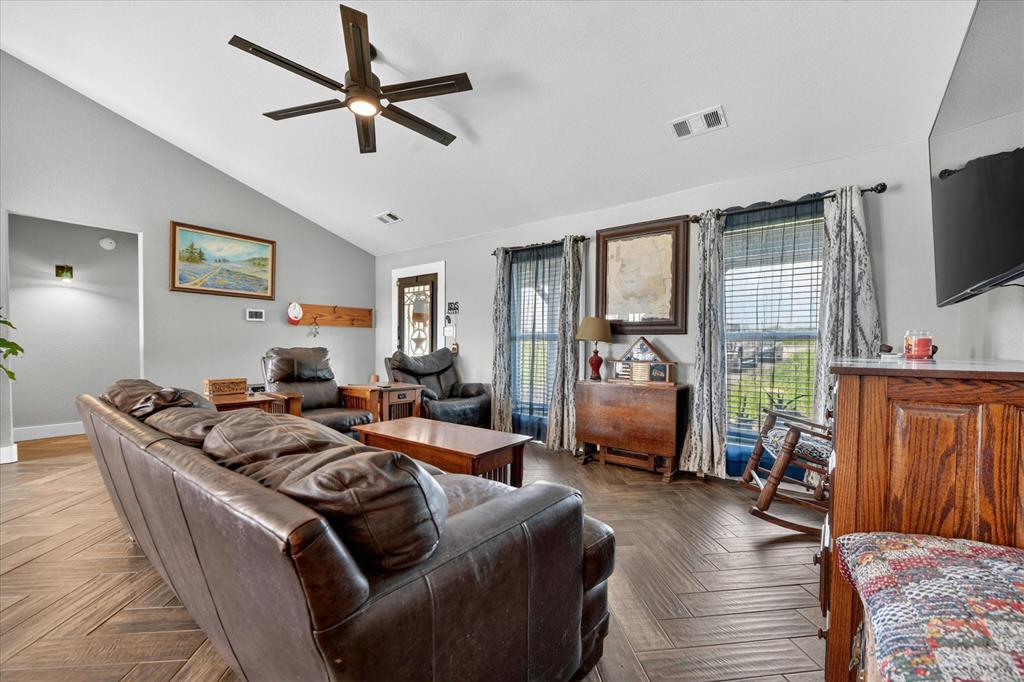 7145 Donald Road Krum, TX 76249 - Photo 4 of 35 a living room with furniture fireplace and a flat screen tv