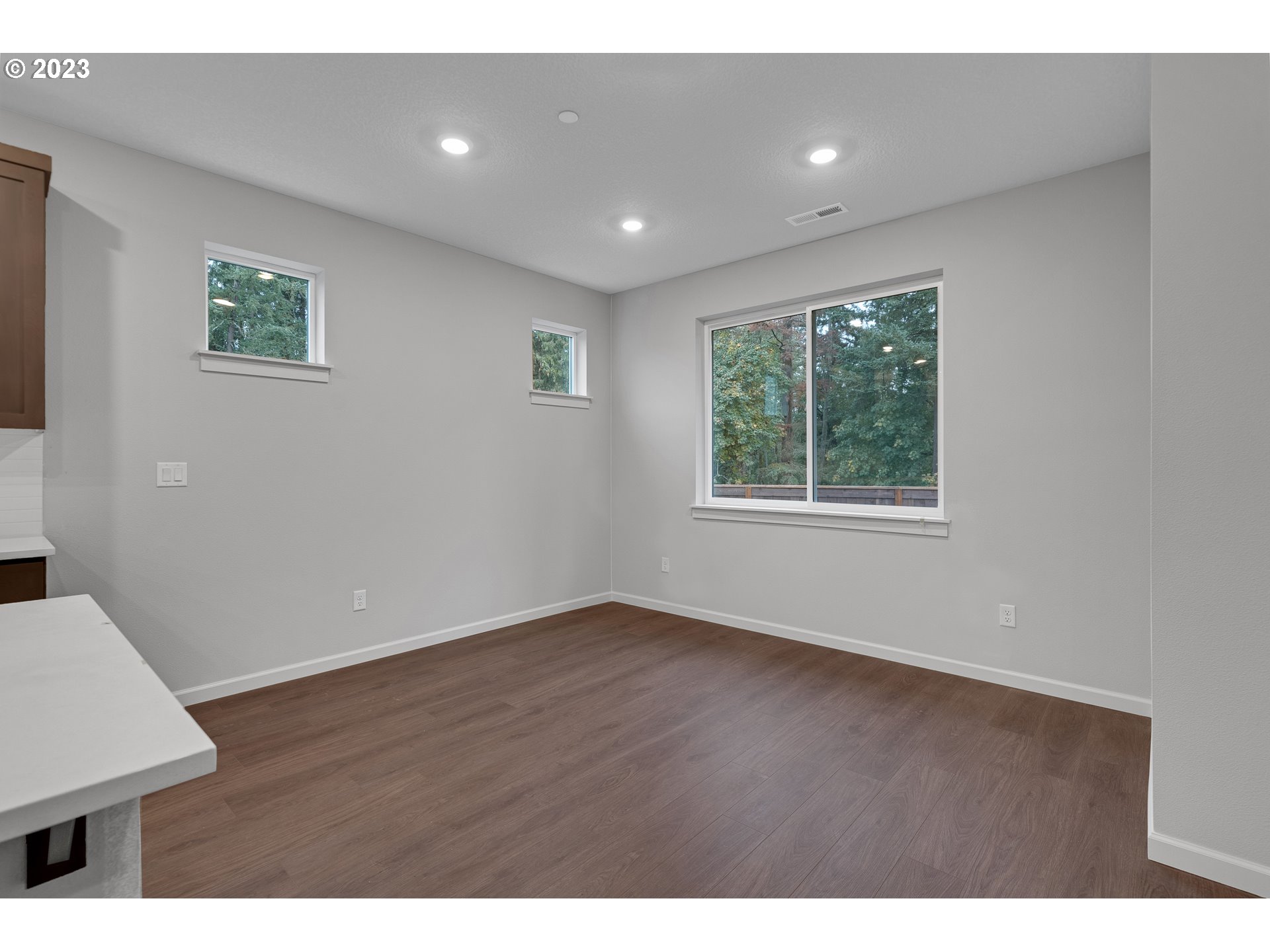 724 South 29th Court Ridgefield, WA 98642 - Photo 13 of 27 a view of an empty room with wooden floor and a window