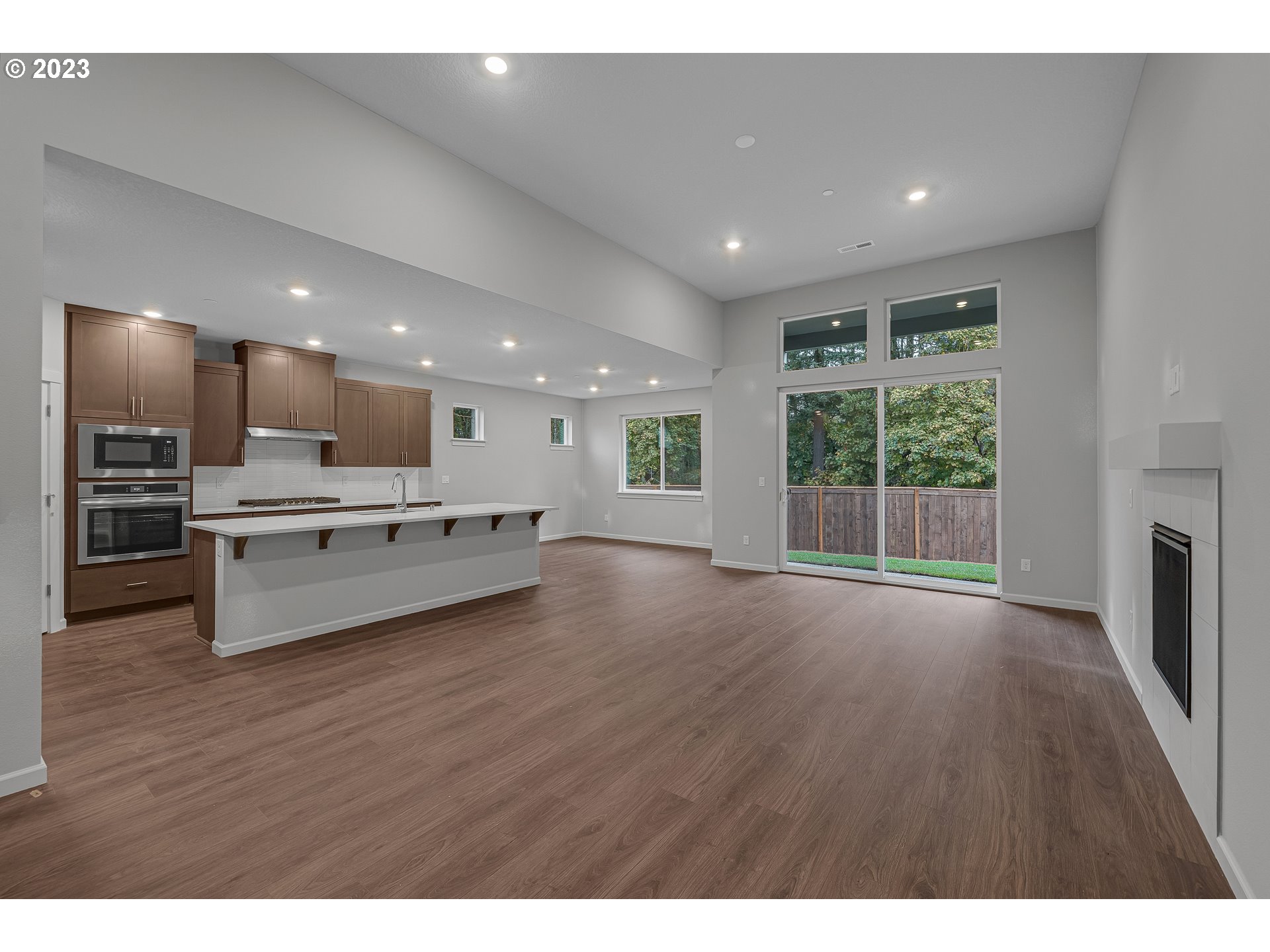 724 South 29th Court Ridgefield, WA 98642 - Photo 9 of 27 a open kitchen with stainless steel appliances kitchen island wooden floors and center island