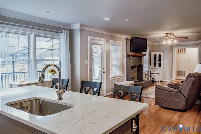 a living room with furniture and large windows