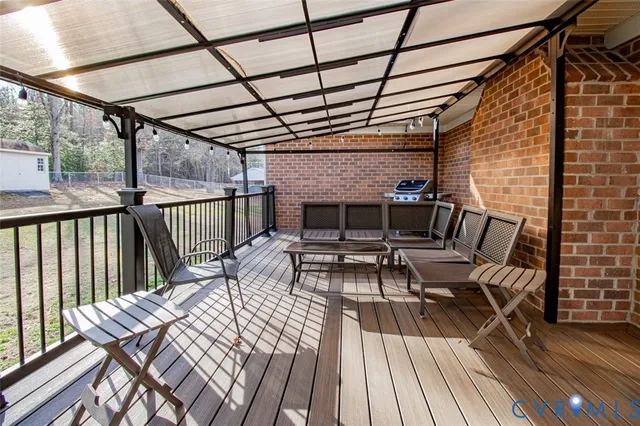 a view of deck with table and chairs