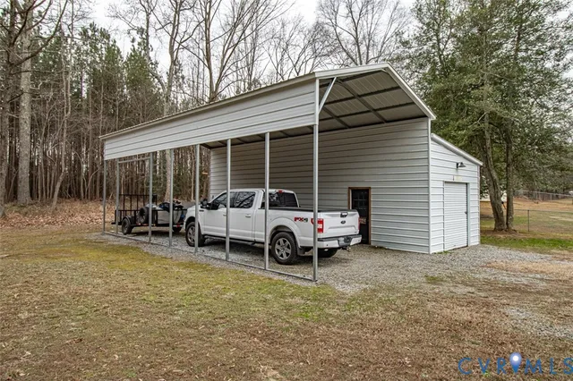 a backyard of a house with barbeque oven and outdoor seating
