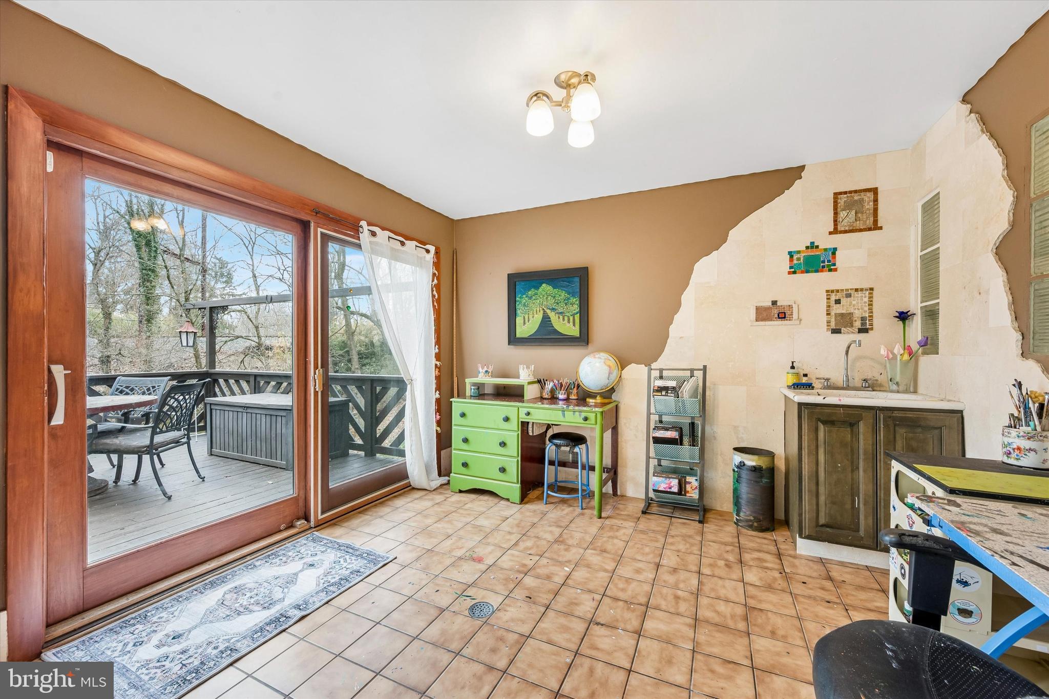 2 Lake Avenue Wallingford, PA 19086 - Photo 13 of 60 a living room with furniture a fireplace and a large window