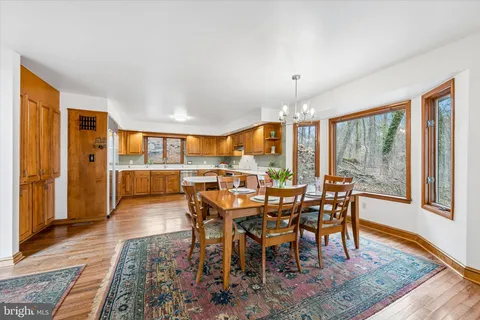 a bathroom with a granite countertop sink a mirror and a shower