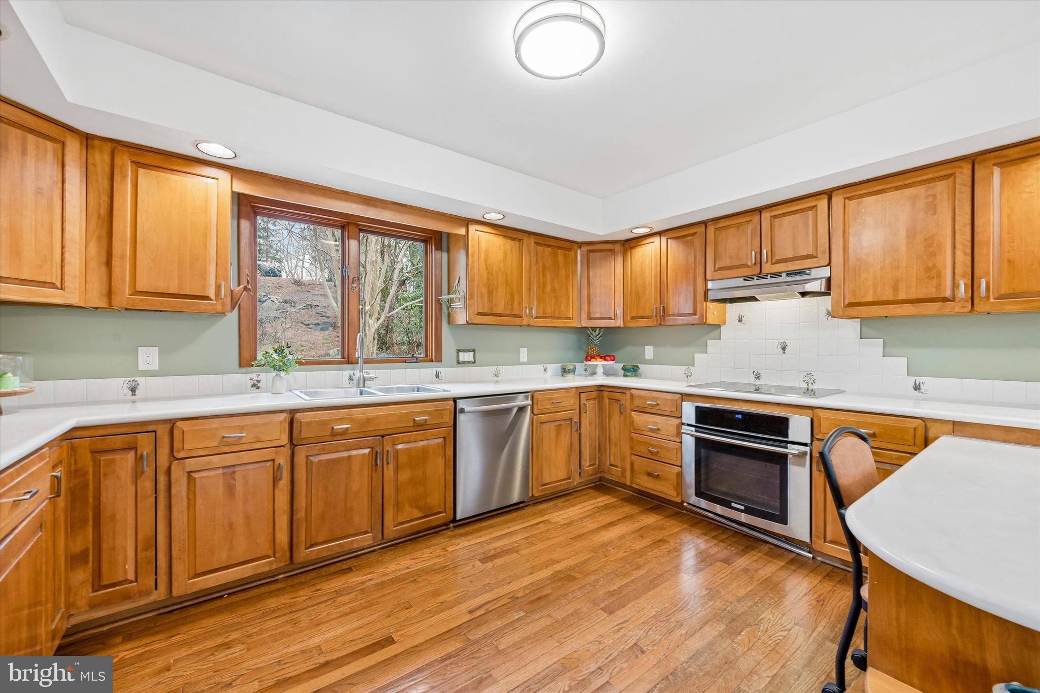 2 Lake Avenue Wallingford, PA 19086 - Photo 18 of 60 a kitchen with stainless steel appliances granite countertop a stove a sink dishwasher and a microwave oven with cabinets