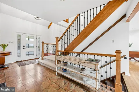 a view of an entryway wooden floor and windows