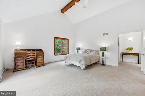 a view of a livingroom with workspace and a window