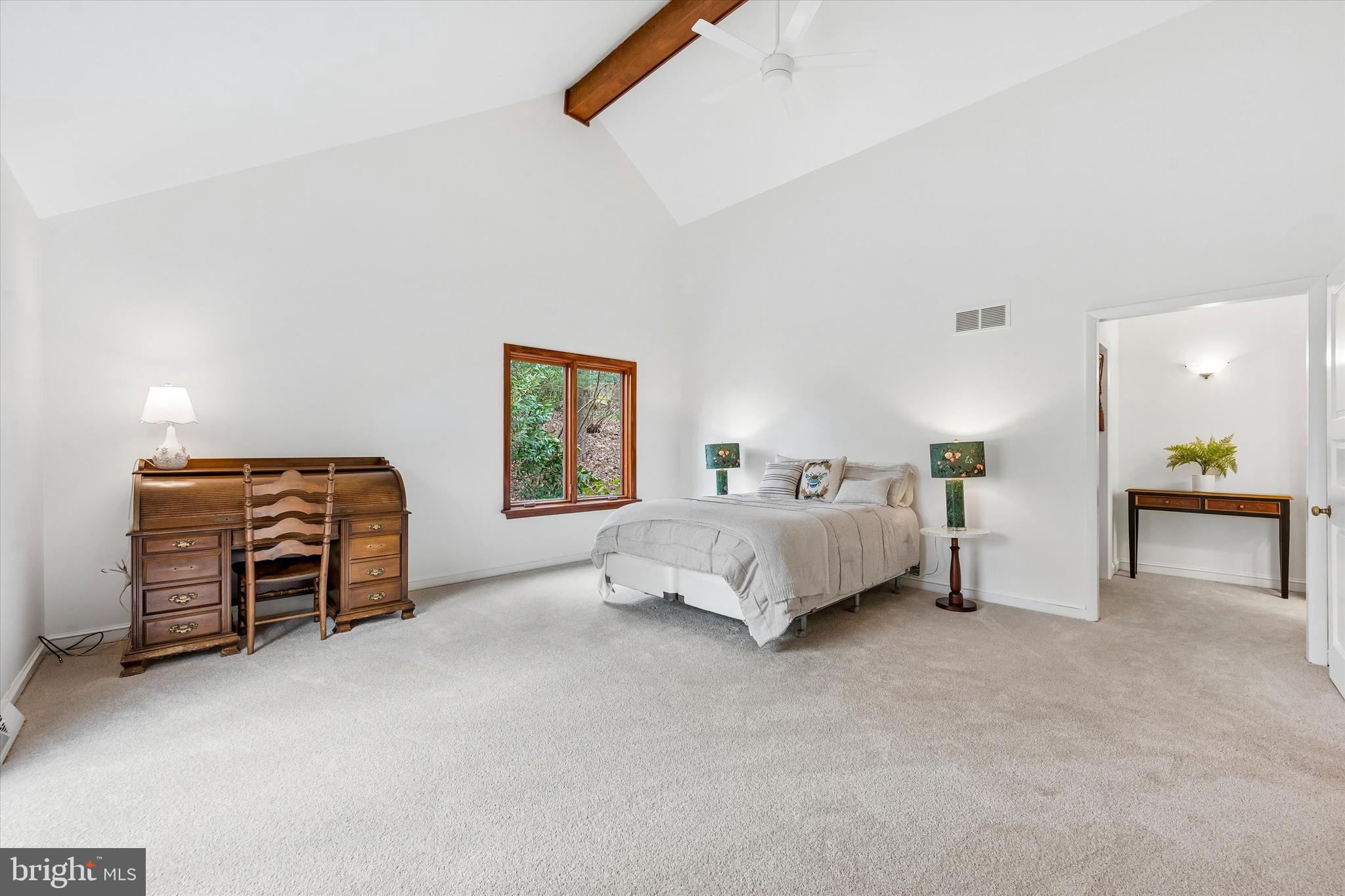 2 Lake Avenue Wallingford, PA 19086 - Photo 26 of 60 a spacious bedroom with a bed and a chandelier