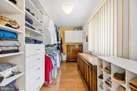 a bathroom with a granite countertop sink a toilet a mirror a vanity a bathtub and shower