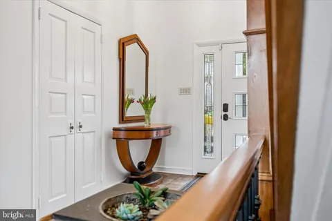 a living room with furniture a wooden floor and next to a window