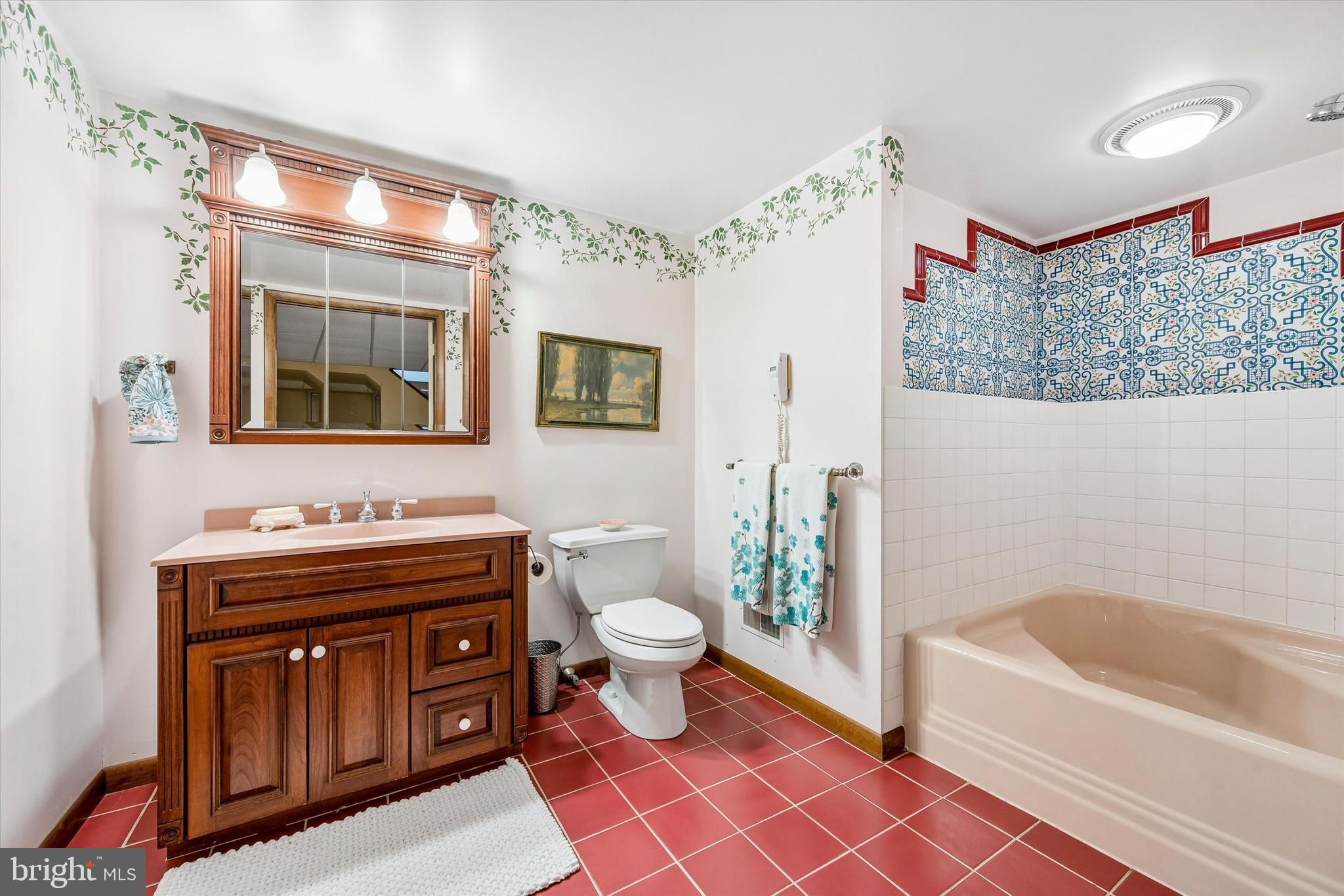 2 Lake Avenue Wallingford, PA 19086 - Photo 41 of 60 a bathroom with a granite countertop sink a toilet a mirror a vanity a bathtub and shower