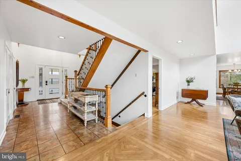 a living room with furniture a large window and a fireplace