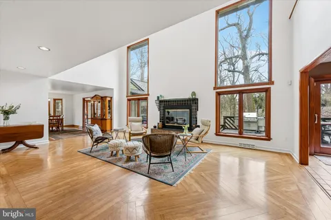 a view of a livingroom with workspace and a window
