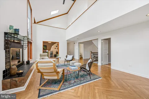 a living room with furniture a fireplace and a large window