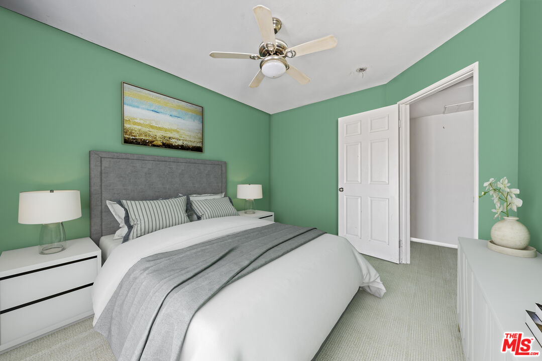 5400 Simpson Avenue, Unit 9 Valley Village, CA 91607 - Photo 14 of 30 a spacious bedroom with a bed and a chandelier