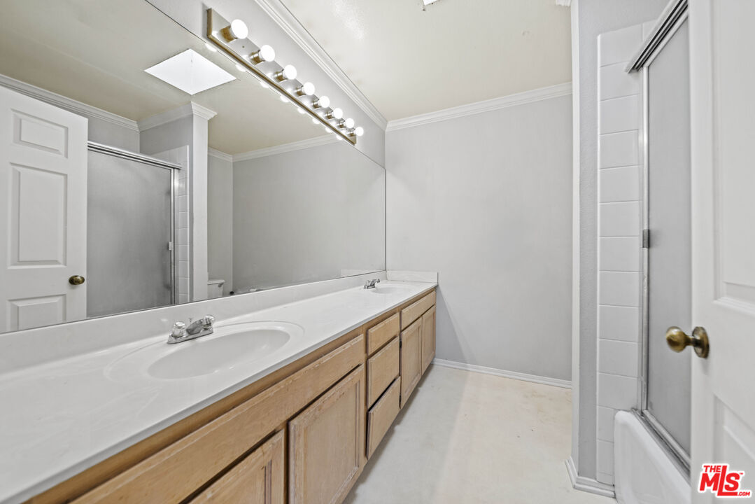 5400 Simpson Avenue, Unit 9 Valley Village, CA 91607 - Photo 26 of 30 a bathroom with a double vanity sink and mirror