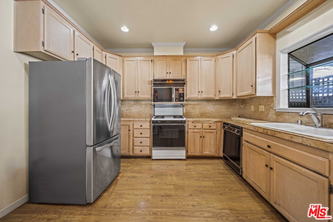 5400 Simpson Avenue, Unit 9 Valley Village, CA 91607 - Photo 9 of 30 a kitchen with granite countertop a refrigerator and a sink
