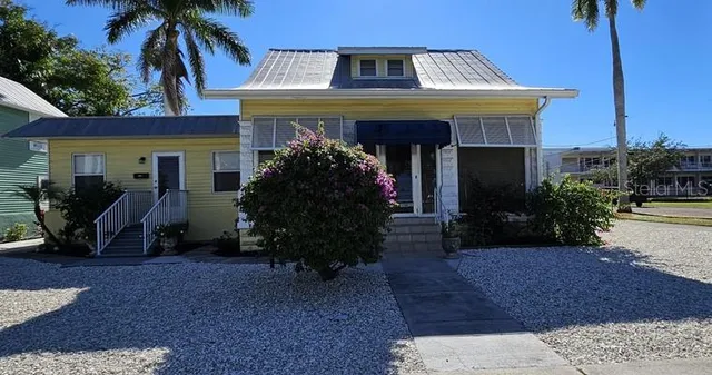 a view of a house with potted plants