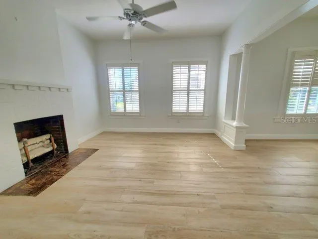 wooden floor in an empty room with a window