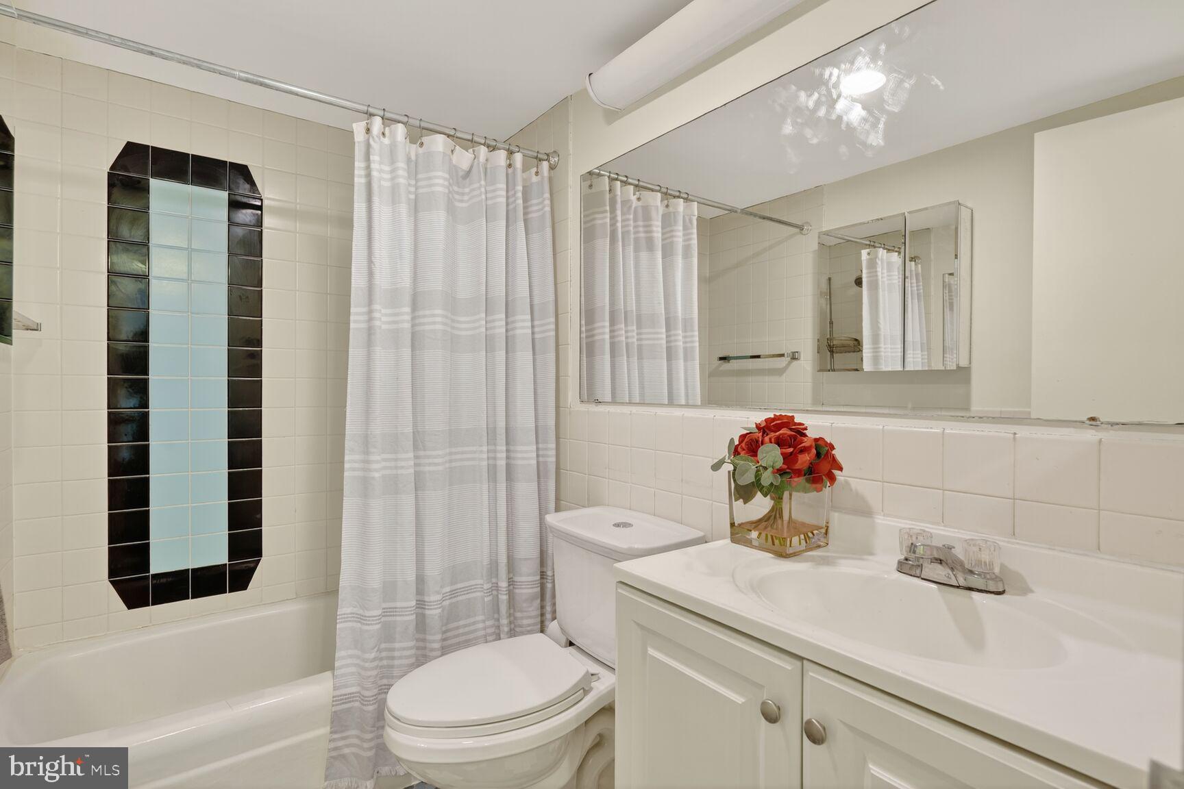 700 7th Street Southwest, Unit 716 Washington, DC 20024 - Photo 11 of 23 a bathroom with a sink toilet vanity and shower