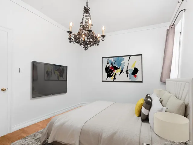 a bedroom with a bed and a painting on the wall