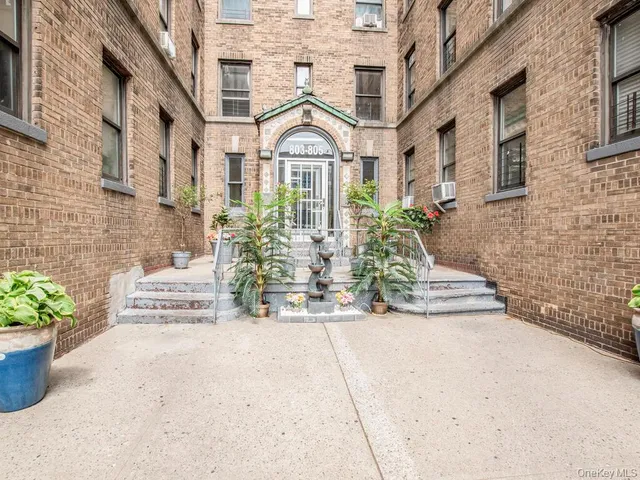 a view of a building with potted plants