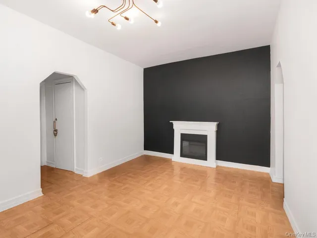 a view of an empty room with a fireplace